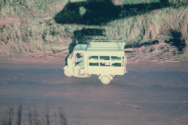 1967-shadow-of-army-uh-1-helicopter-overflies-a-3-wheel-truck-on-road_14307513308_o