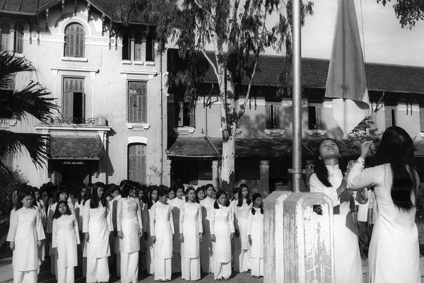 Republic of South Vietnam. Hoisting a flag during roll call at a girls' highschool in Hue. The school opened its doors again only a few days after liberation. June 1975.

Photo by Spremberg