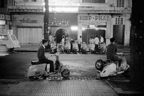 07 Nov 1967, Saigon, South Vietnam --- Youths and their motor-scooters linger around this section of South Vietnam's capital until the wee hours of the morning. The scene may change if the Saigon government lowers the draft age from 20 to 18 years. --- Image by © Bettmann/CORBIS