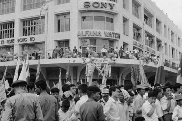 Anti-Communist Students demonstrating in Saigon (Ho Chi Minh City) on the 10th anniversary of the 1954 Geneva accords, South Vietnam, July 1964. In the background, effigies of French President Charles de Gaulle and Vietnamese leader Ho Chi Minh are depicted being hung hand in hand. (Photo by Nguyen Van Duc/Michael Ochs Archives/Getty Images)