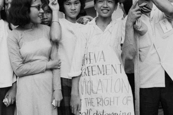 Anti-Communist Students demonstrating in Saigon (Ho Chi Minh City) on the 10th anniversary of the 1954 Geneva accords, South Vietnam, July 1964. One young woman wears a sign reading 'Geneva Agreement Violation of the Right of Self-Determination'. (Photo by Nguyen Van Duc/Michael Ochs Archives/Getty Images)